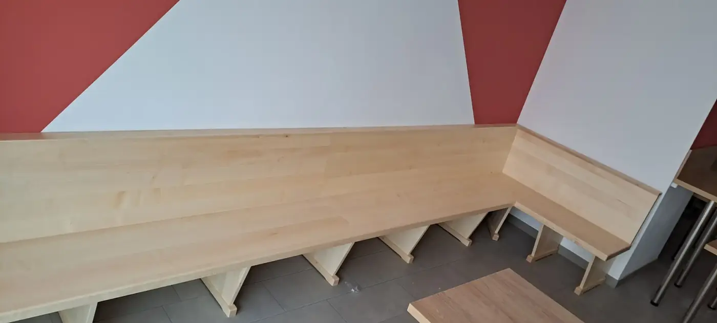 Lange maßgefertigte Eckbank aus hellem Holz